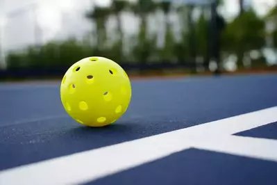 close up of a pickleball on the court