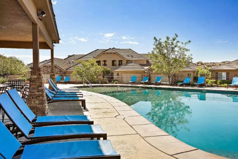 lounge chairs next to pool