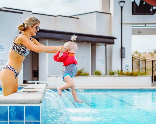 mother and daughter playing in pool