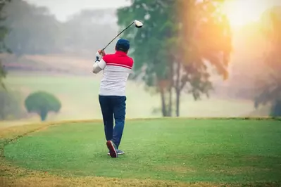 man playing on golf course