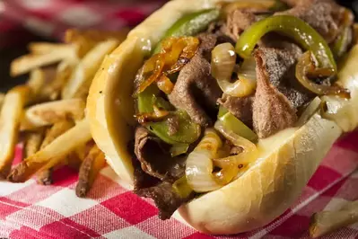 philly cheesesteak sandwich with french fries