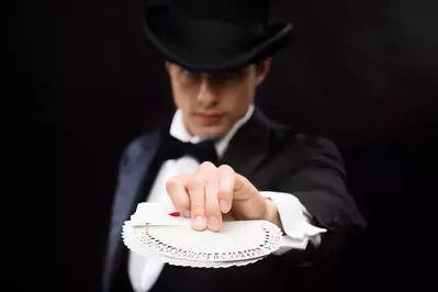 magician holding cards in magic show