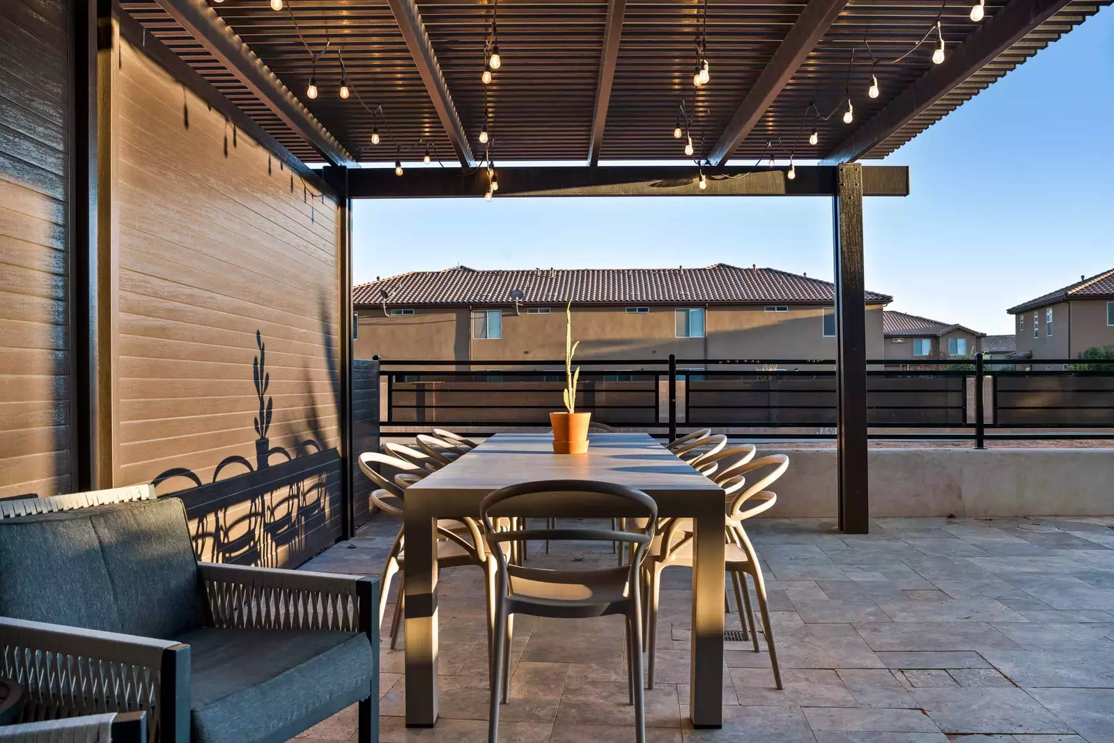 Back Yard Dining area covered with a Pergola and lighting