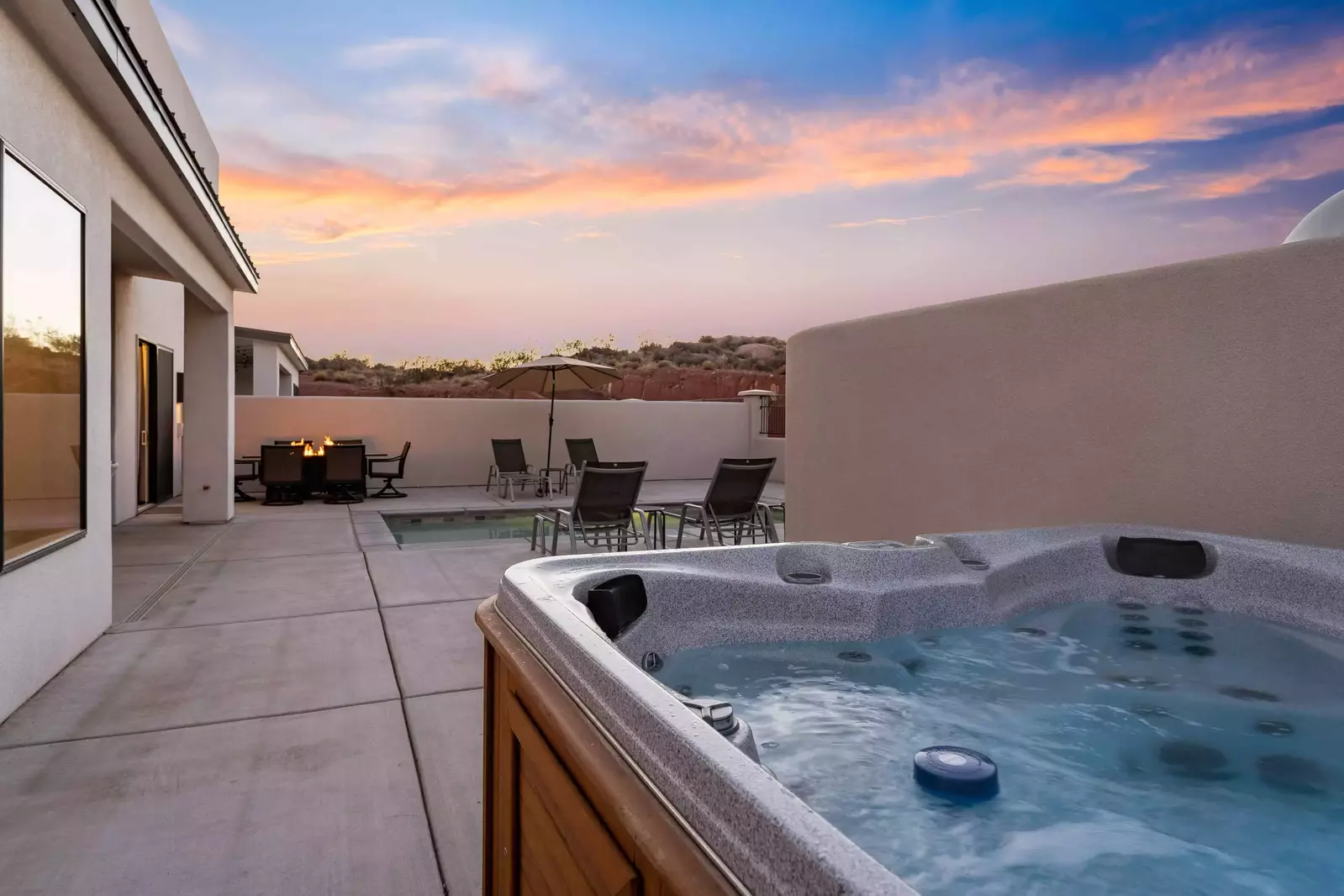 Patio With Private Hot Tub, Tables, and Chairs