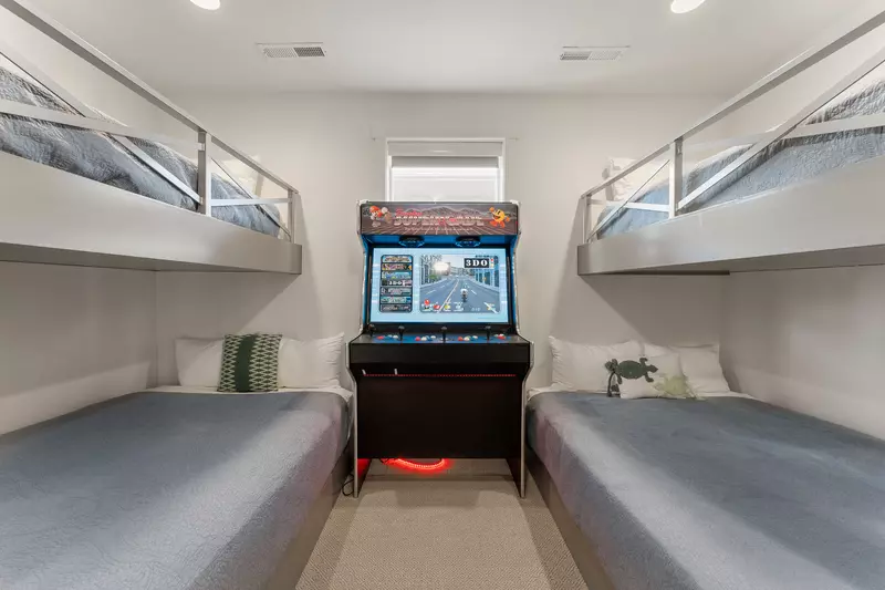 Your kids will love this fun bunk room with a classic arcade game right between the beds for endless entertainment.