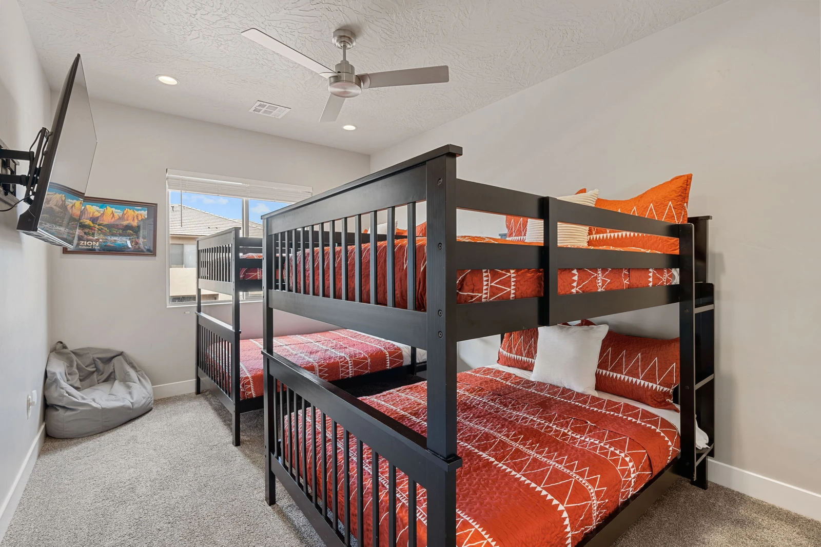 Your kids will love this fun bunk room with cozy bedding, entertainment setup, and comfy bean bag for relaxing after adventure-filled days.